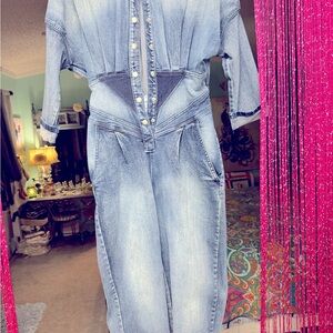Blue Jean jump suit with elastic at the bottom and pleats in the back.